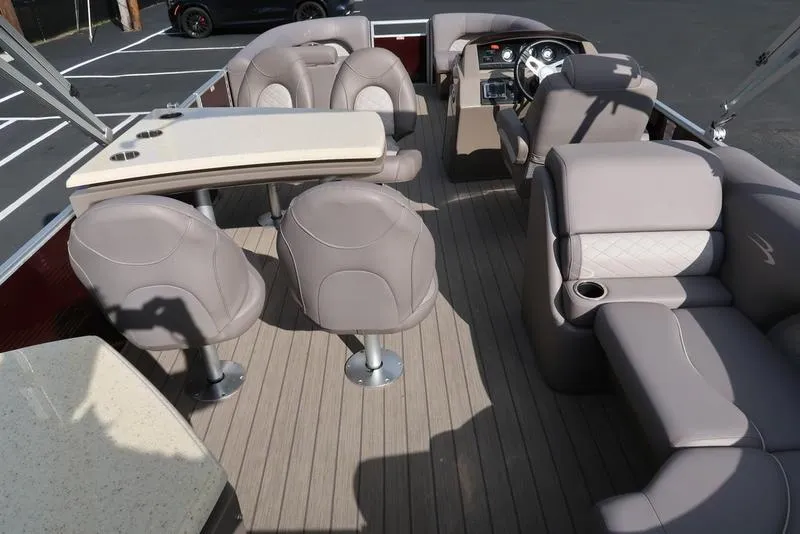 Slide: The Image of 2018 Bennington 23SPDXP pontoon boat interior with plush seating and steering console. - 29