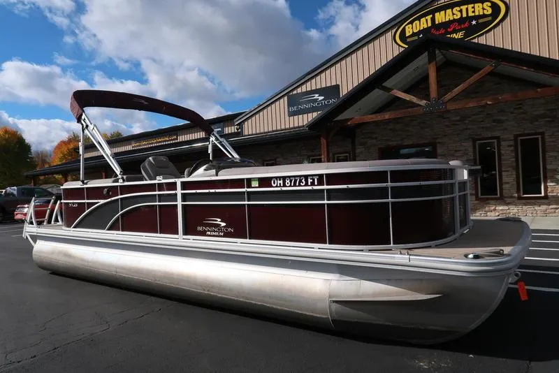Slide: The Image of 2018 Bennington 23SPDXP pontoon boat parked outside dealership. - 3