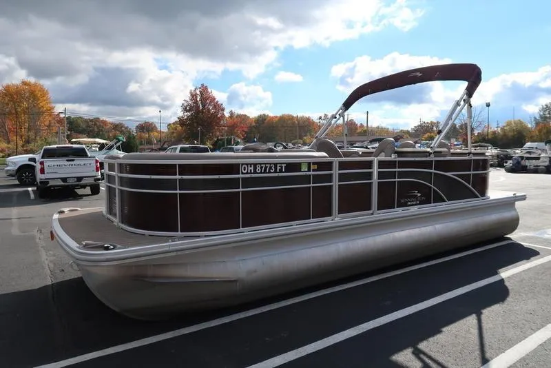 Slide: The Image of 2018 Bennington 23SPDXP pontoon boat in parking lot, autumn trees in background. - 6