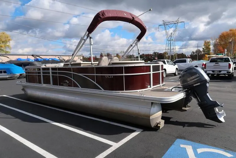 Slide: The Image of 2018 Bennington 23SPDXP pontoon boat with Yamaha outboard motor in parking lot. - 8