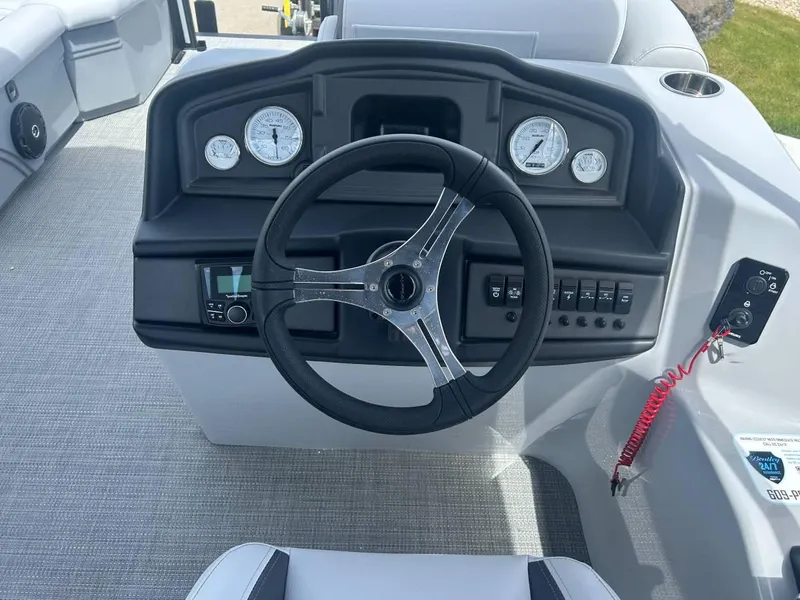 Slide: The Image of 2024 Bentley Pontoons Legacy Cruise XL dashboard with steering wheel and gauges. - 4
