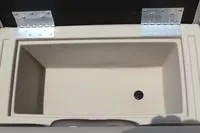 Slide: The Image of 2024 Bentley Pontoons Legacy Cruise XL storage compartment with drain plug. - 8