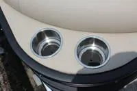 Slide: The Image of 2024 Bentley Pontoons Legacy Cruise XL cup holders, sleek design, beige and black finish. - 9