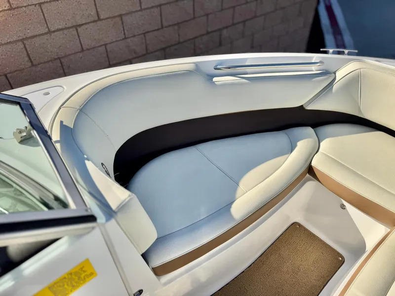 Slide: The Image of 2017 Cobalt 220S boat interior with white cushioned seating. - 12