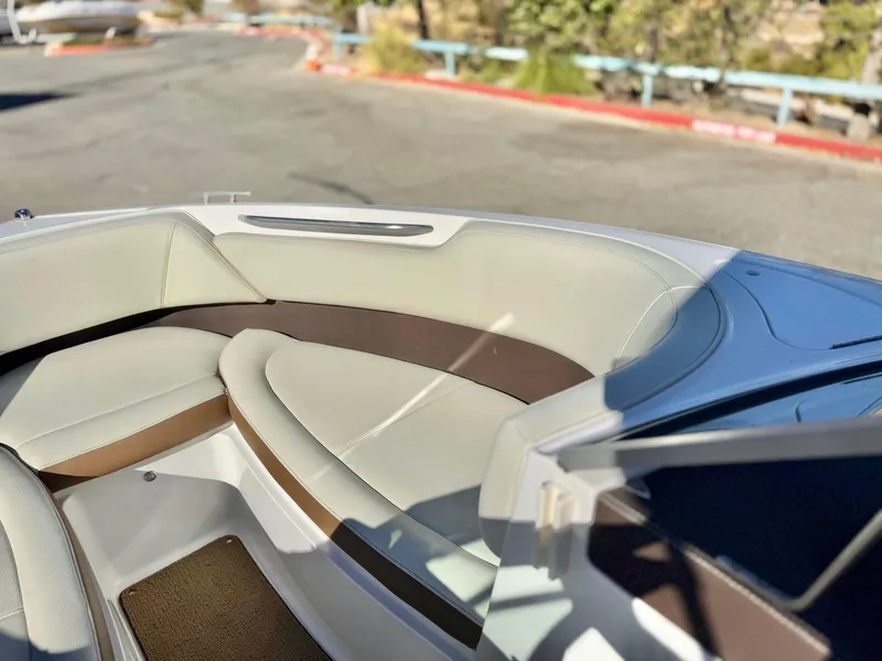 Slide: The Image of 2017 Cobalt 220S boat interior with beige and brown seating. - 13