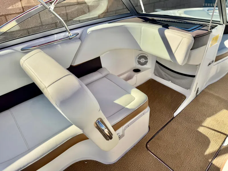 Slide: The Image of 2017 Cobalt 220S boat interior with white leather seating and beige carpet. - 14