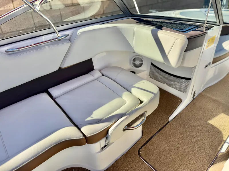 Slide: The Image of 2017 Cobalt 220S boat interior with white seating and beige carpet. - 15