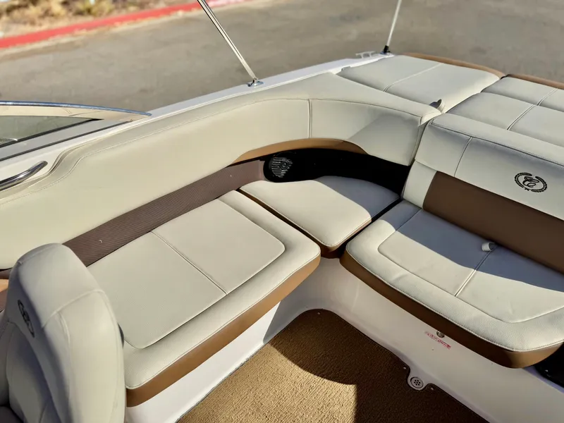 Slide: The Image of 2017 Cobalt 220S boat interior with beige and brown seating. - 17