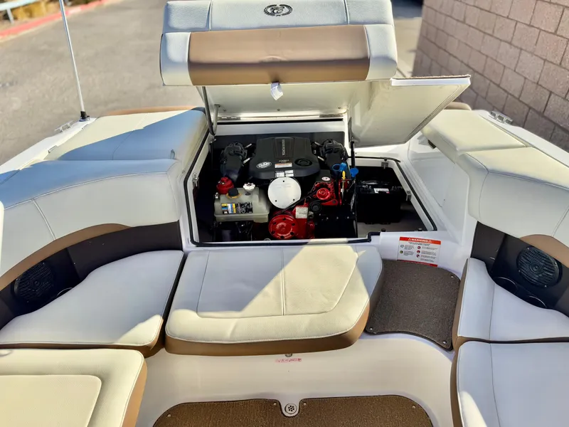 Slide: The Image of 2017 Cobalt 220S boat engine compartment with cushioned seating. - 23