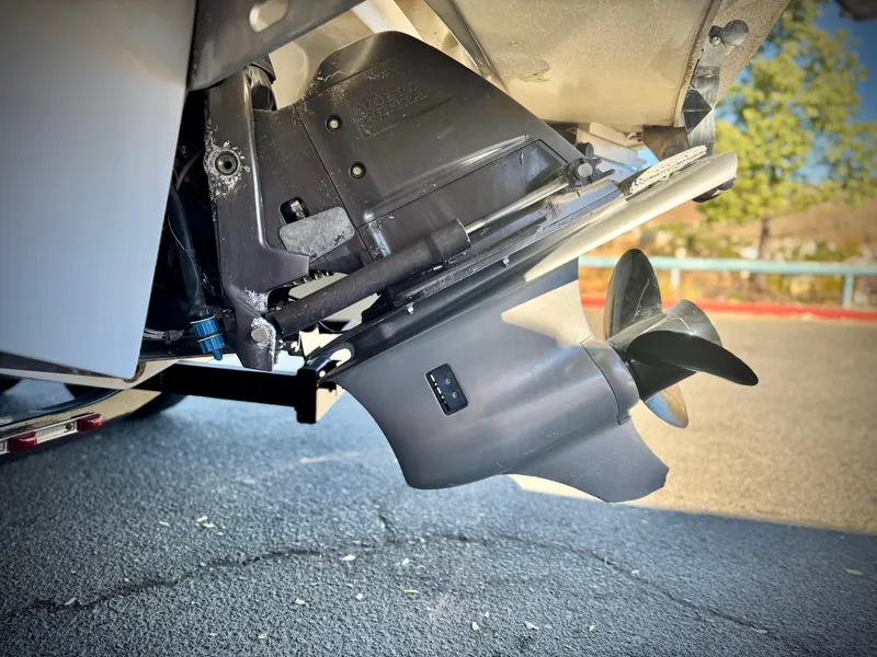 Slide: The Image of Close-up of a 2017 Cobalt 220S boat propeller and outdrive on pavement. - 7