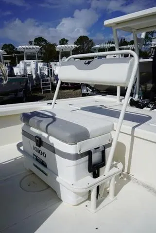 Slide: The Image of 2025 Mako 18 LTS boat with Igloo cooler seat on deck. - 12