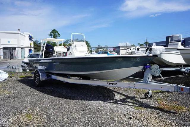 Slide: The Image of 2025 Mako 18 LTS boat on trailer, parked outdoors under clear sky. - 3