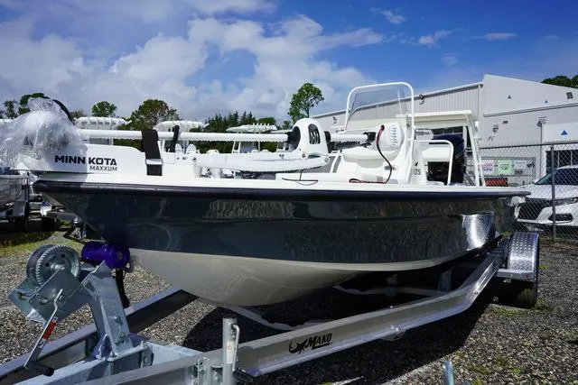 Slide: The Image of 2025 Mako 18 LTS boat on trailer, equipped with Minn Kota motor. - 5