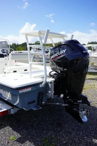 Slide: The Image of 2025 Mako 18 LTS boat with Mercury outboard motor, parked outdoors. - 8