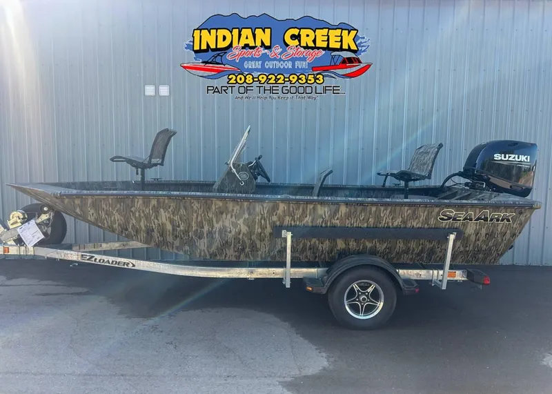 Slide: The Image of 2024 SeaArk Shadow 187 boat on trailer, camo design, Suzuki motor, Indian Creek logo. - 1
