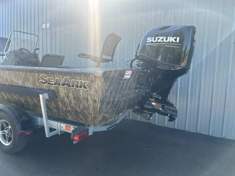 Slide: The Image of 2024 SeaArk Shadow 187 boat with Suzuki outboard motor, parked on a trailer. - 4