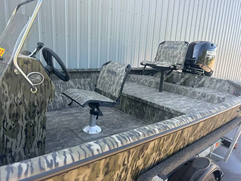 Slide: The Image of 2024 SeaArk Shadow 187 boat with camouflage seats and Suzuki outboard motor. - 6