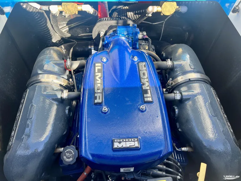 Slide: The Image of 2018 MasterCraft XT22 Ilmor 5000 MPI engine, blue cover, detailed view. - 12