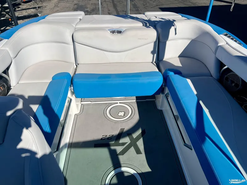 Slide: The Image of 2018 MasterCraft XT22 boat interior with blue and white seating. - 5
