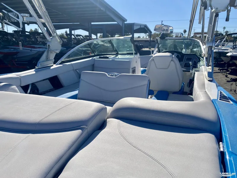 Slide: The Image of 2018 MasterCraft XT22 boat interior with plush seating and modern dashboard. - 7