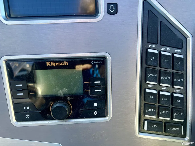 Slide: The Image of 2018 MasterCraft XT22 control panel with Klipsch audio system and navigation buttons. - 8