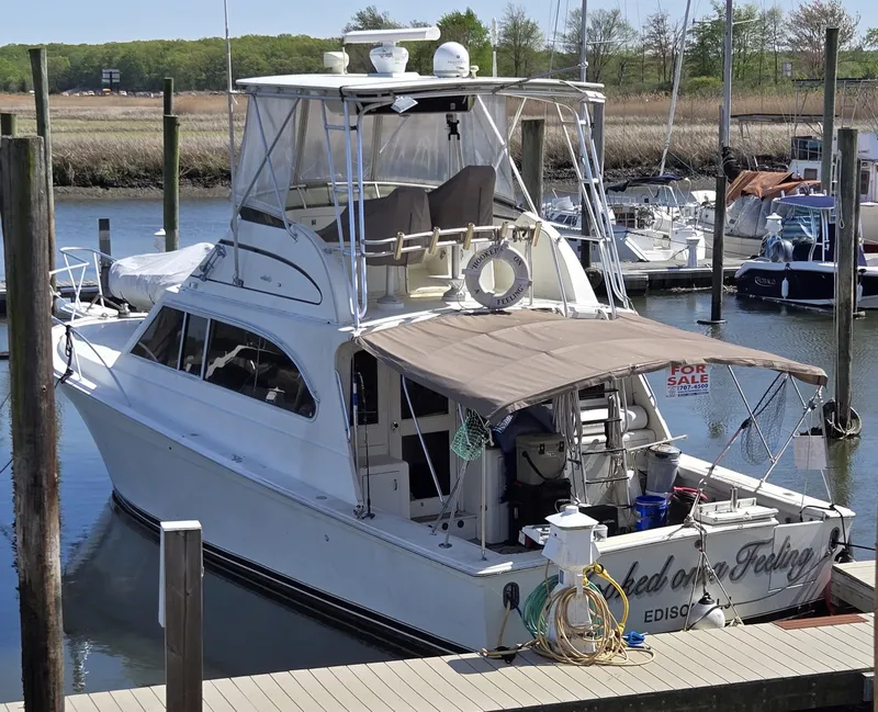 The Image of 1995 Egg Harbor 42 Convertible yacht docked, featuring a "For Sale" sign. - 0