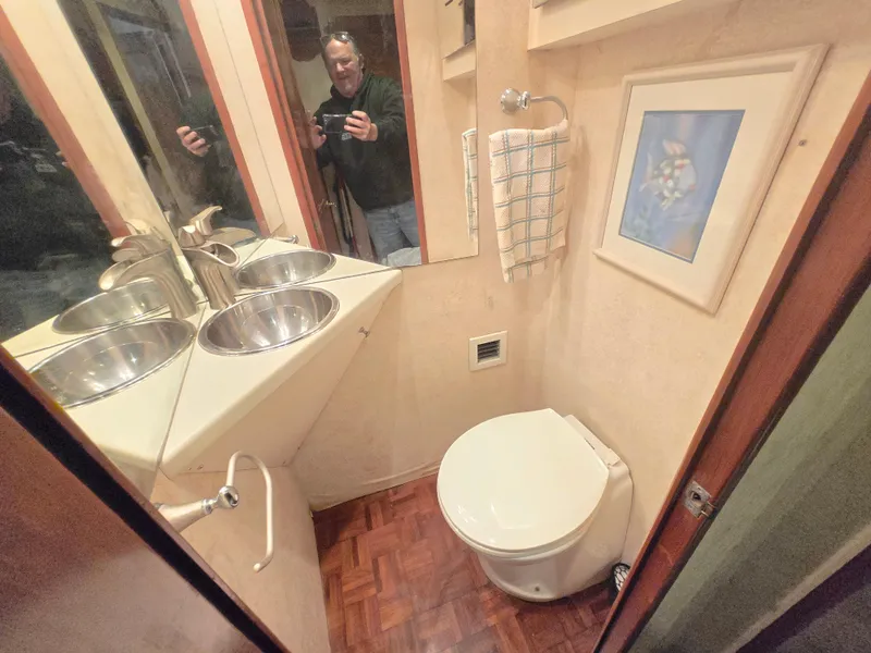 Slide: The Image of Bathroom interior of 1995 Egg Harbor 42 Convertible yacht with dual sinks and artwork. - 10