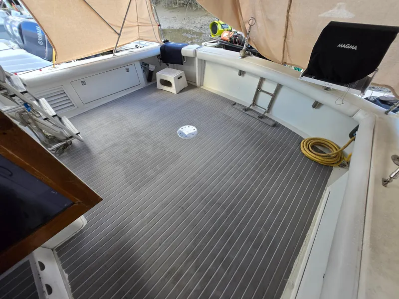 Slide: The Image of Spacious deck of a 1995 Egg Harbor 42 Convertible boat with seating and equipment. - 11