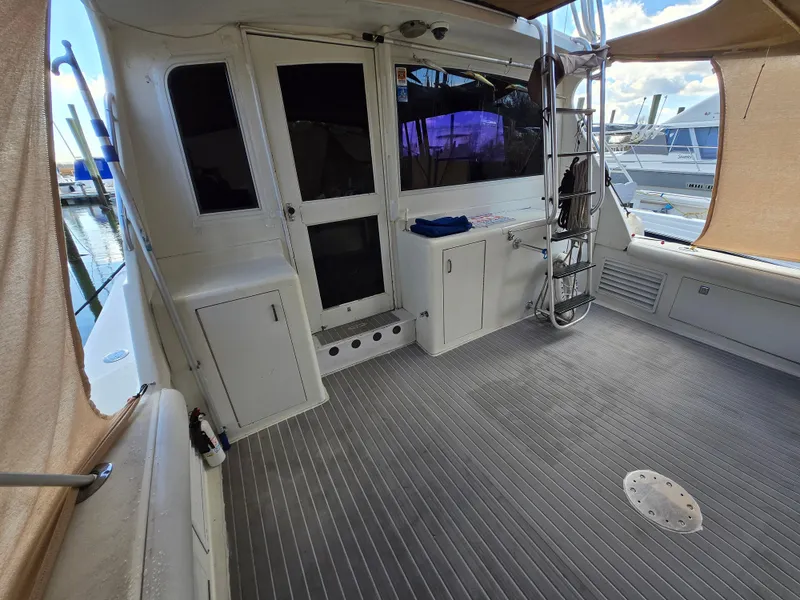 Slide: The Image of 1995 Egg Harbor 42 Convertible yacht deck with ladder and storage cabinets. - 13