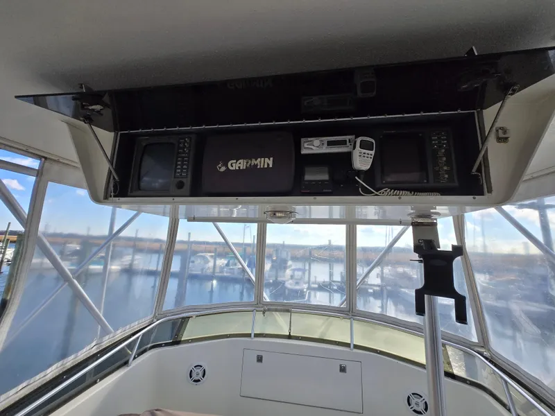 Slide: The Image of 1995 Egg Harbor 42 Convertible yacht helm with Garmin navigation system and marina view. - 15