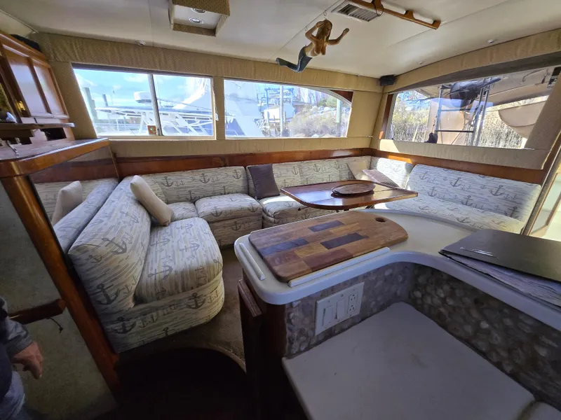 Slide: The Image of Interior of 1995 Egg Harbor 42 Convertible yacht with spacious seating and wooden accents. - 23