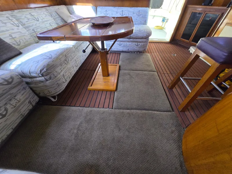 Slide: The Image of Interior of 1995 Egg Harbor 42 Convertible yacht with cozy seating and wooden table. - 24
