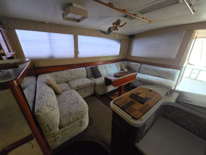 Slide: The Image of Interior of a 1995 Egg Harbor 42 Convertible yacht with plush seating and wooden accents. - 3