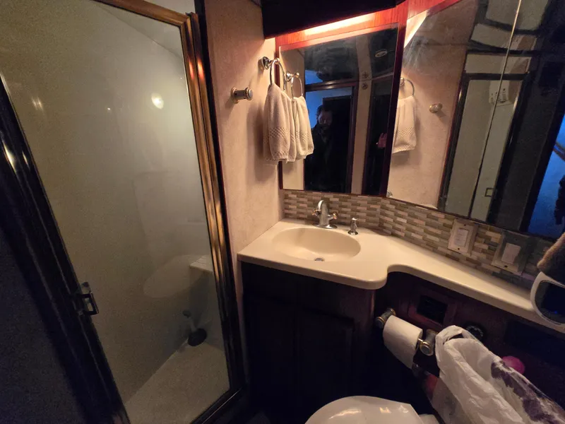 Slide: The Image of Bathroom interior of a 1995 Egg Harbor 42 Convertible yacht, featuring a shower and sink. - 31