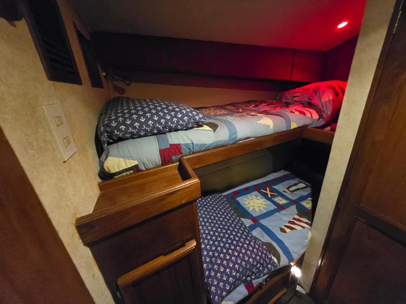 Slide: The Image of Bunk beds in 1995 Egg Harbor 42 Convertible yacht cabin with nautical-themed bedding. - 35