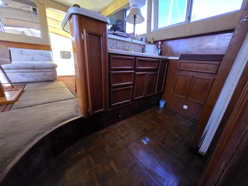 Slide: The Image of Interior of 1995 Egg Harbor 42 Convertible yacht with wooden cabinetry and seating area. - 36