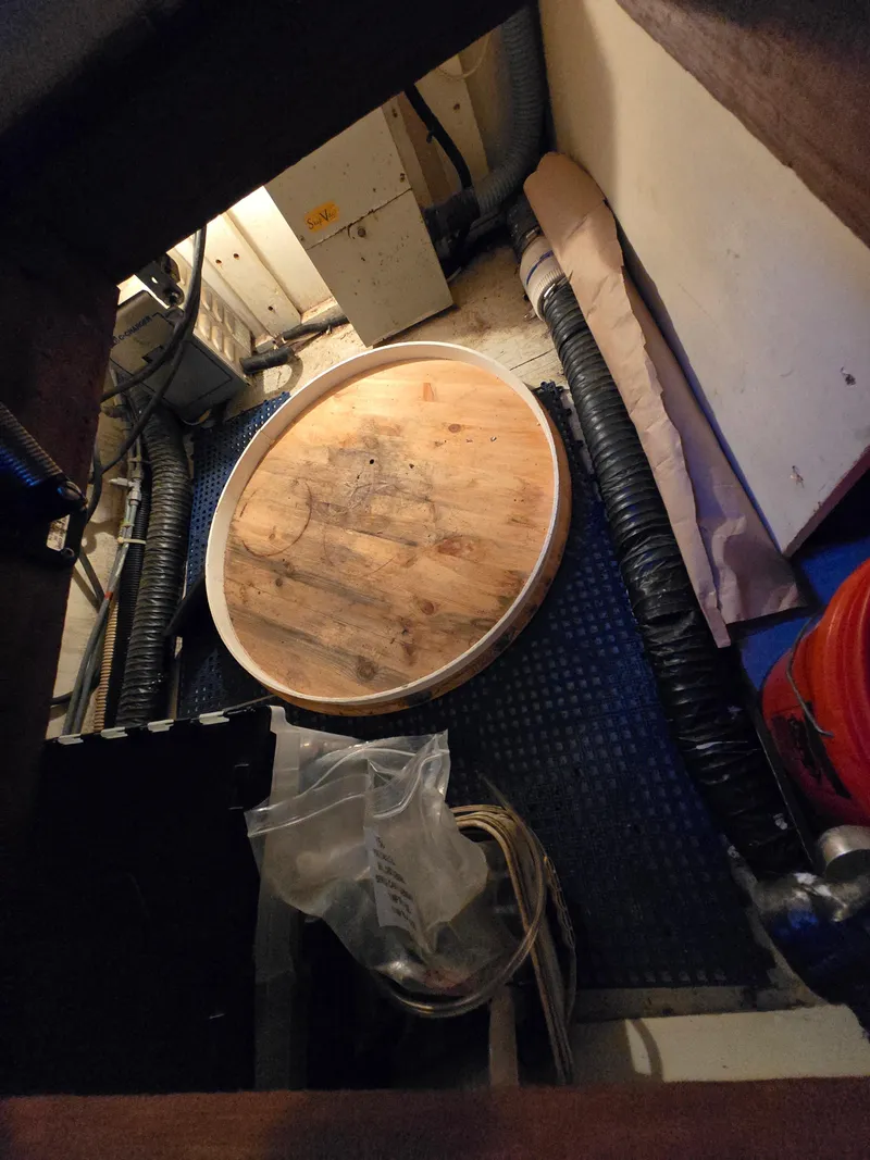 Slide: The Image of Engine room of 1995 Egg Harbor 42 Convertible with wooden cover and cables. - 39