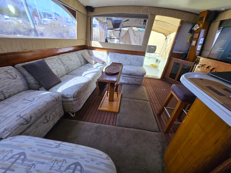 Slide: The Image of Interior of 1995 Egg Harbor 42 Convertible yacht with cozy seating and wooden accents. - 40