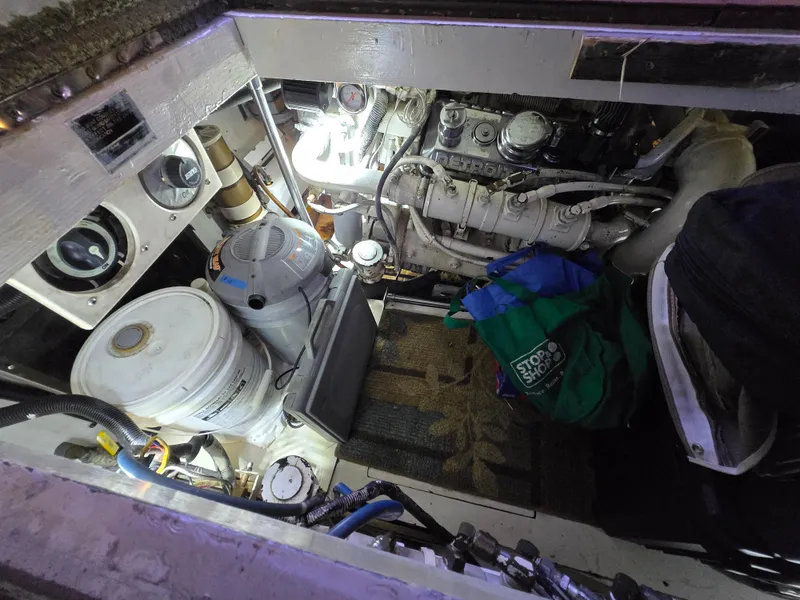 Slide: The Image of Engine room of a 1995 Egg Harbor 42 Convertible boat, showing machinery and storage items. - 43