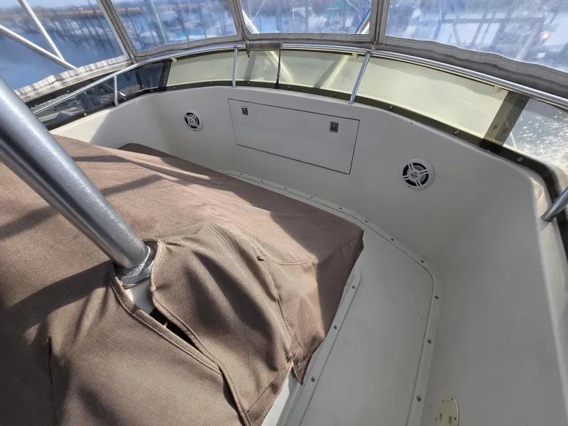 Slide: The Image of 1995 Egg Harbor 42 Convertible boat interior with covered seating and windows. - 45