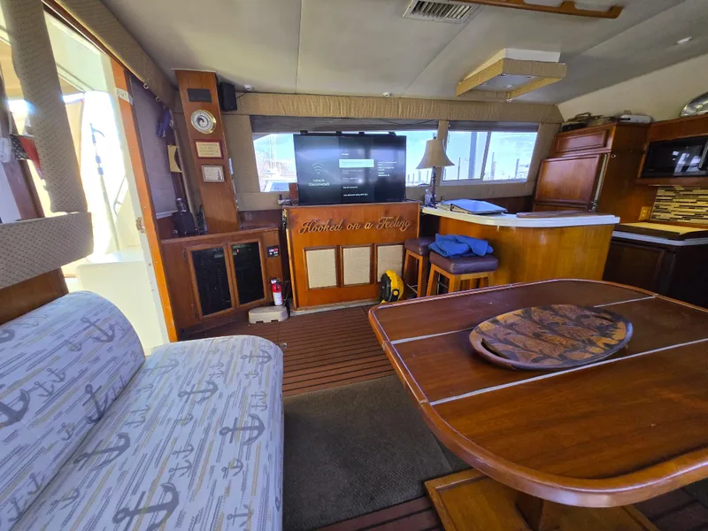 Slide: The Image of Interior of a 1995 Egg Harbor 42 Convertible yacht with cozy seating and wooden decor. - 5