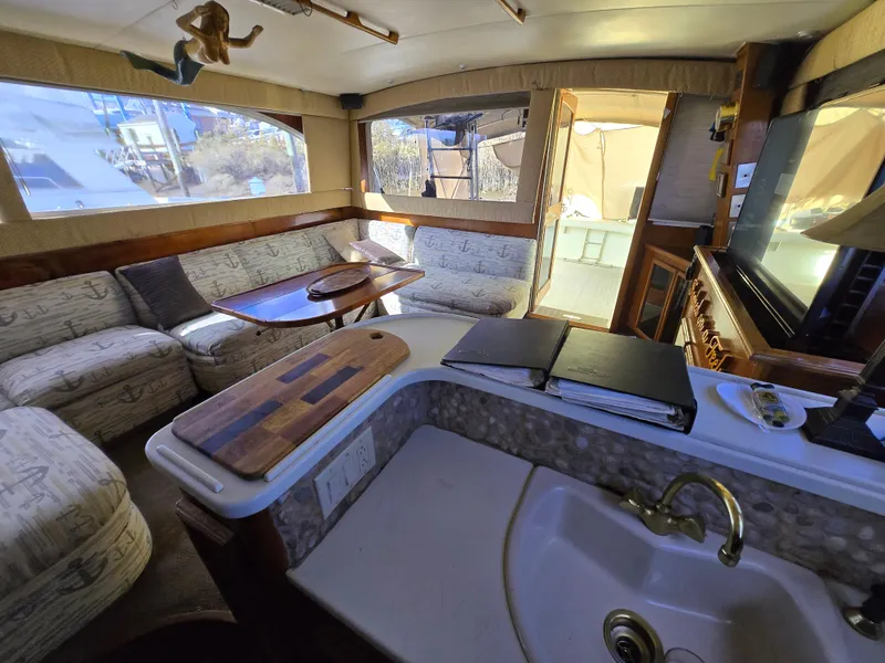 Slide: The Image of Interior of 1995 Egg Harbor 42 Convertible yacht with cozy seating and kitchenette. - 6