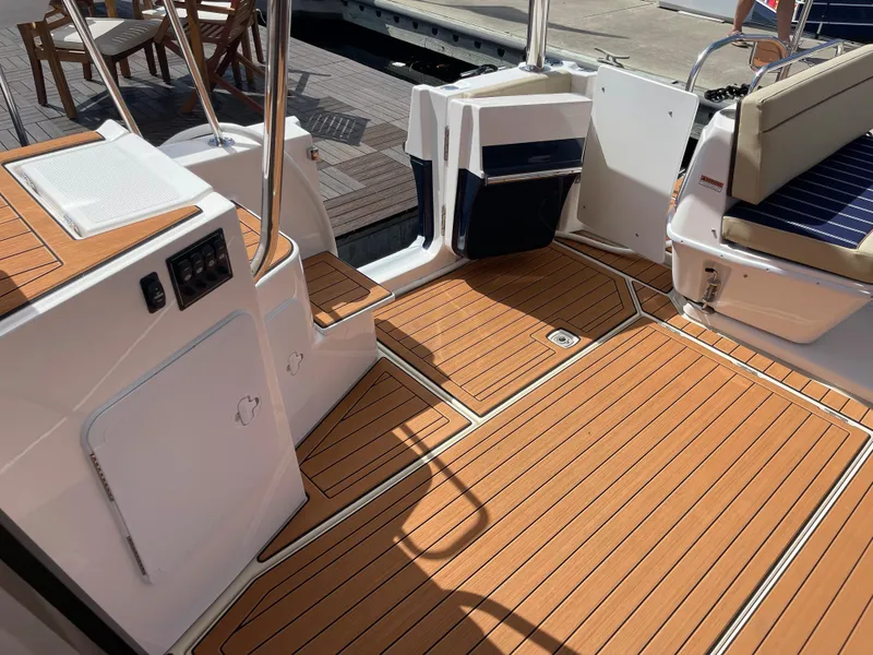 Slide: The Image of 2025 Ranger Tugs 43 Command Bridge with teak deck and seating area. - 13