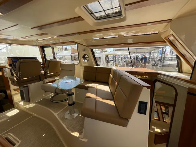 Slide: The Image of Luxurious interior of 2025 Ranger Tugs 43 Command Bridge yacht with plush seating and panoramic windows. - 15
