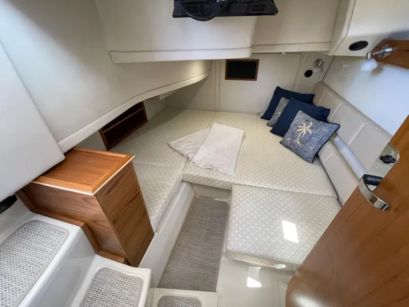 Slide: The Image of Interior cabin of 2025 Ranger Tugs 43 Command Bridge with cozy bedding and cushions. - 16