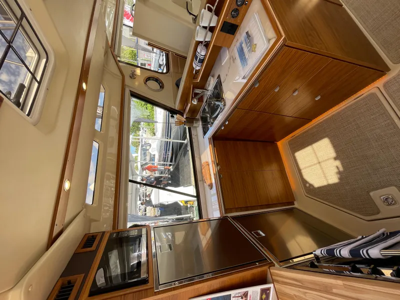 Slide: The Image of Interior of 2025 Ranger Tugs 43 Command Bridge, featuring modern design and spacious seating. - 18