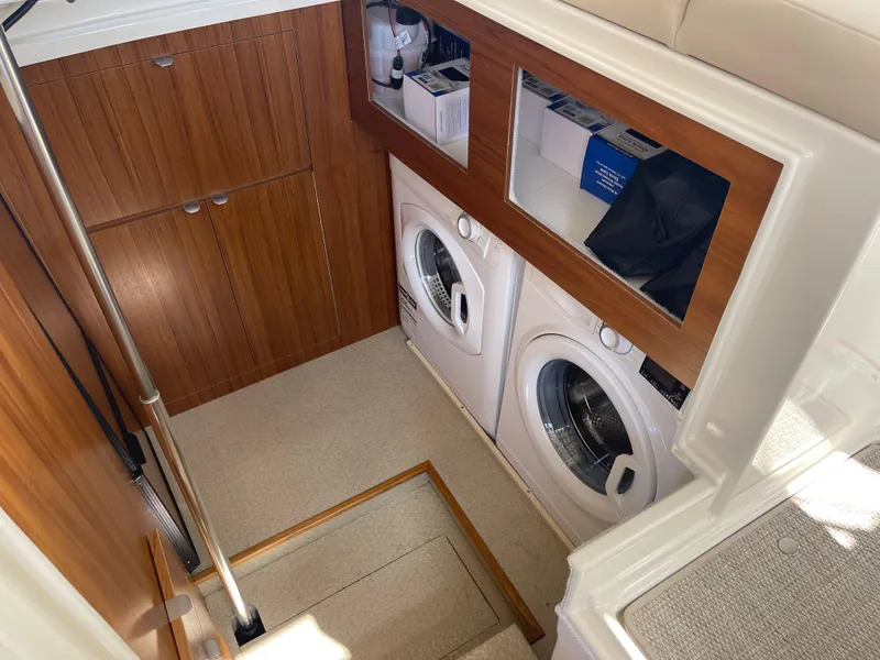 Slide: The Image of Laundry area in 2025 Ranger Tugs 43 Command Bridge with washer and dryer. - 19