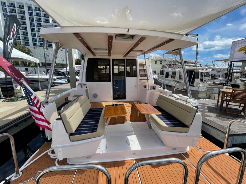 Slide: The Image of 2025 Ranger Tugs 43 Command Bridge yacht with spacious deck and seating area. - 2