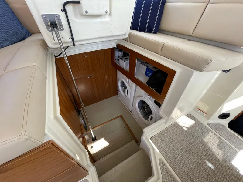 Slide: The Image of Interior of 2025 Ranger Tugs 43 Command Bridge with laundry area and seating. - 20