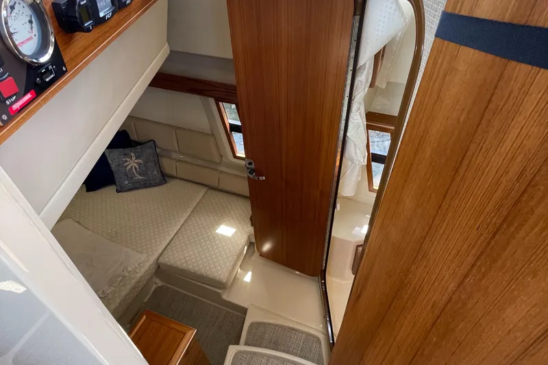 Slide: The Image of Interior of 2025 Ranger Tugs 43 Command Bridge, featuring cozy cabin and wooden finishes. - 21